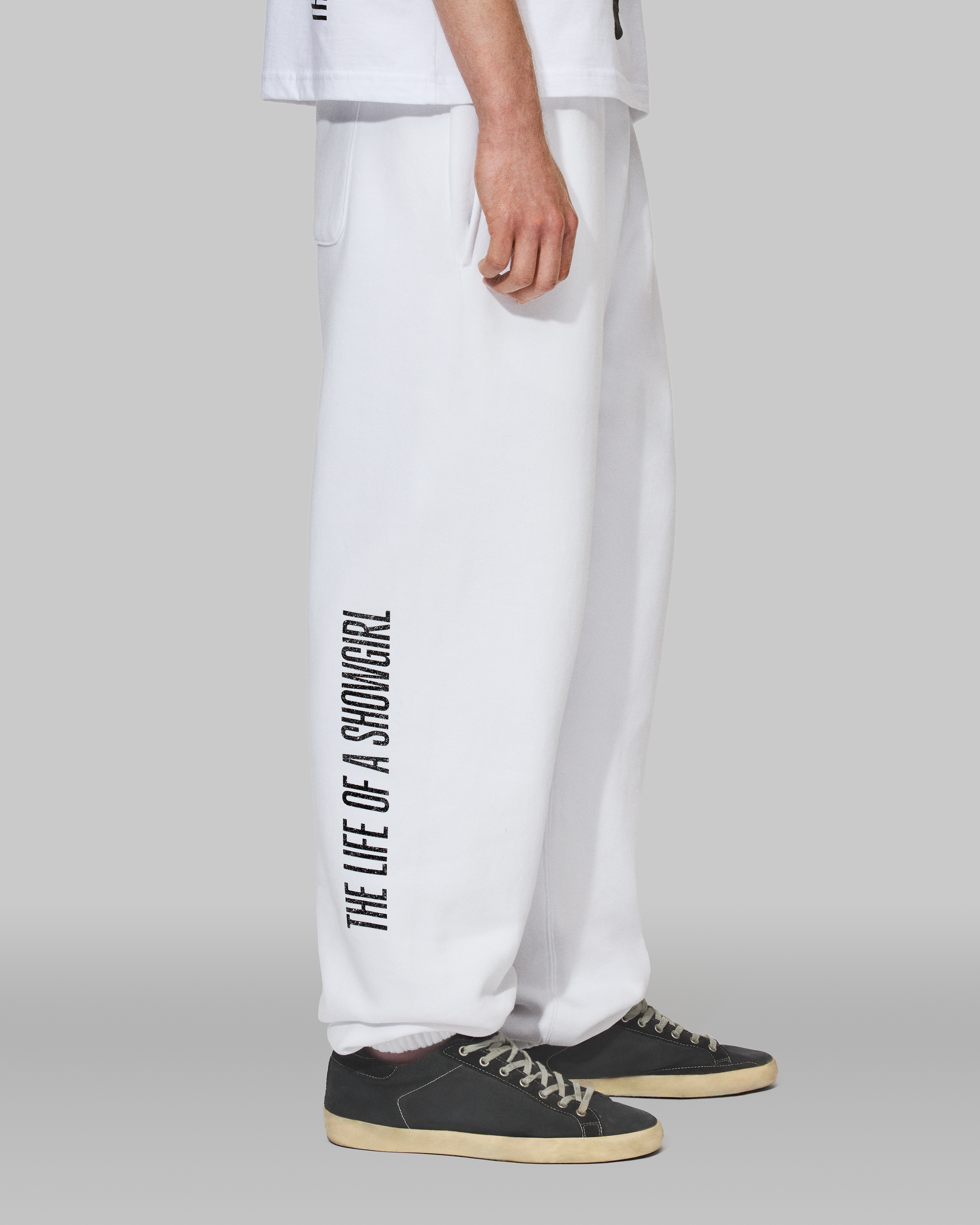 The Life of a Showgirl Shiny Bug White Sweatpants Side 2 on Model